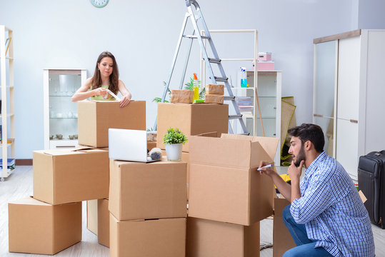 Family packing household goods with moving boxes in Bangalore